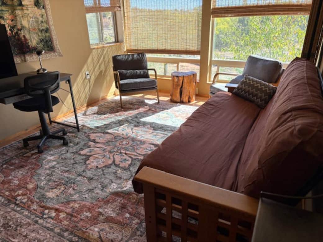 Bedroom 1 with sofa bed and workspace