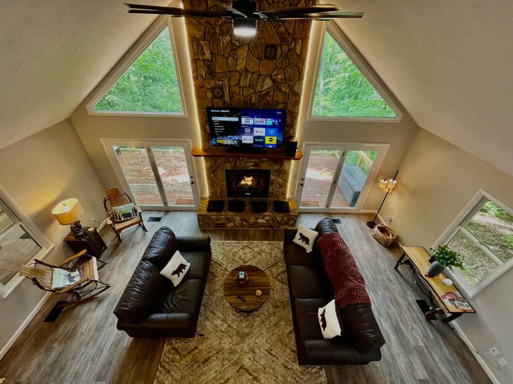 View from the loft where you can see the new living room suite, cozy rockers, and seating cushions on the fireplace. 