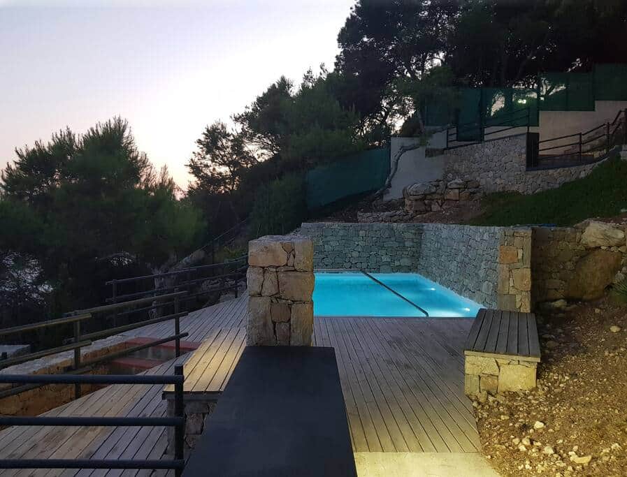 Swimming pool and surrounding deck at dusk Swimming pool and surrounding deck at dusk