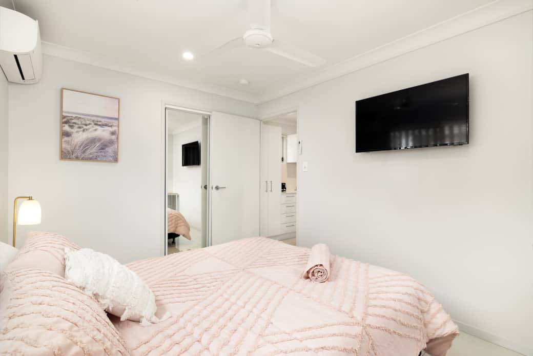 Bedroom: Comfortable room featuring wall-mounted TV