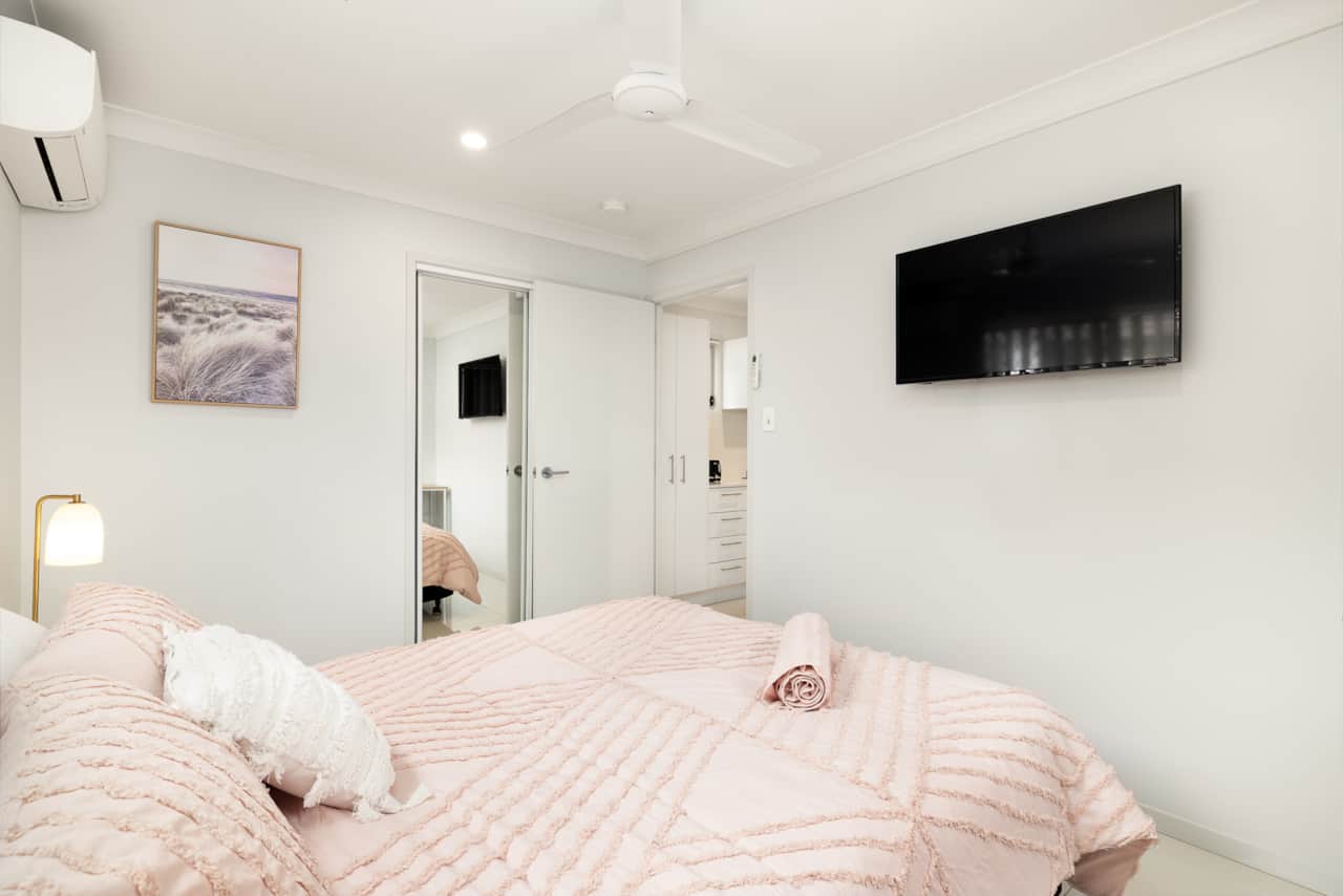 Bedroom: Comfortable room featuring wall-mounted TV