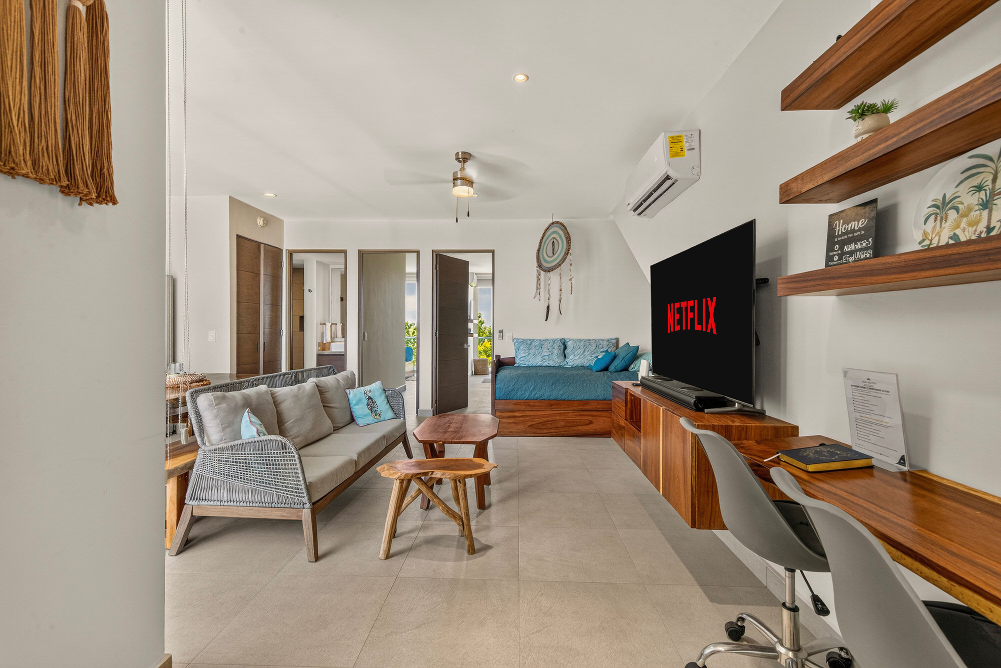 Dedicated workspace with a comfy desk, chair, shelving, and natural light for productive workdays.