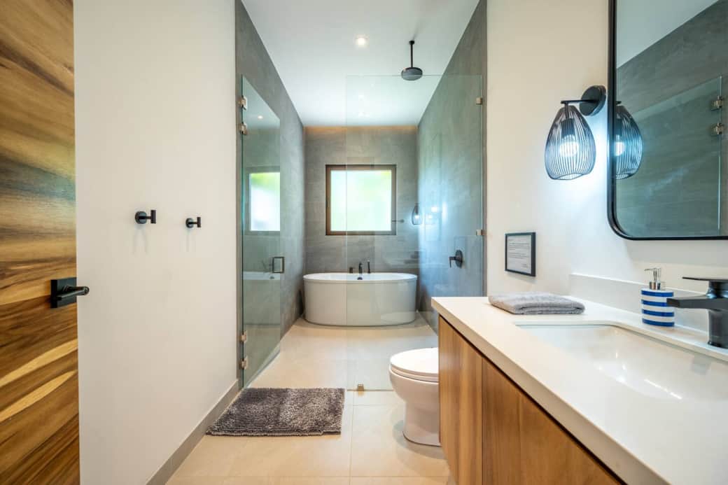Stand alone bath with separate rain shower at  bedroom 2 (downstairs).