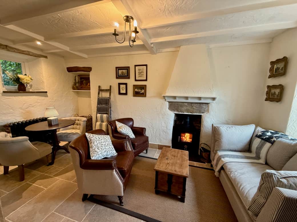 Cosy living room with log burner and comfortable sofas at Arwel Cottage, Llanbedrog