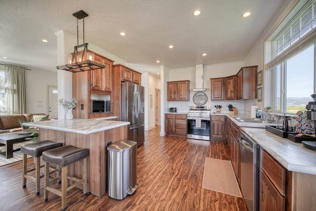 Entertain in style in this family-friendly, fully equipped, spacious kitchen! Enjoy plenty of seating with the island stools and dining table! Please use provided trivets for hot items! 