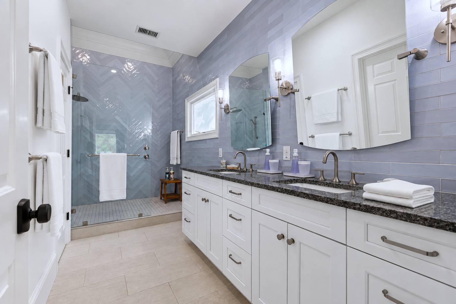 Get ready together with dual sinks, a long vanity, fresh towels, and a spacious walk-in shower.