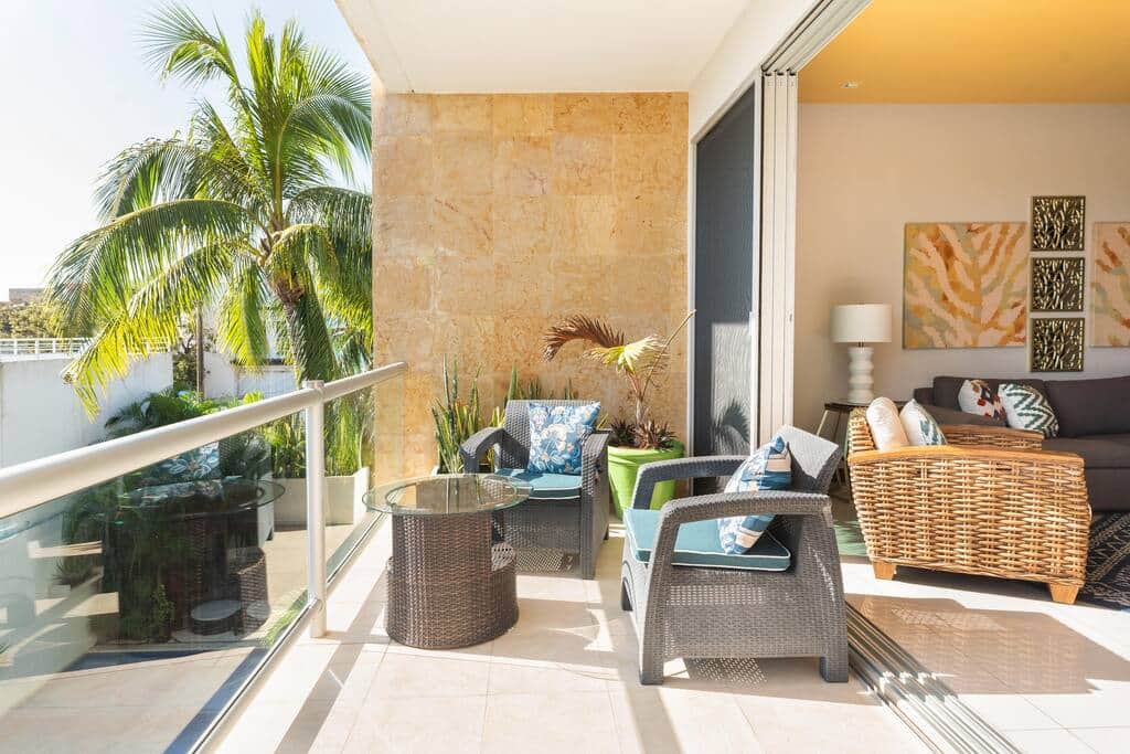 Balcony with two seating areas. Sliding doors fully open to provide you with indoor/outdoor living