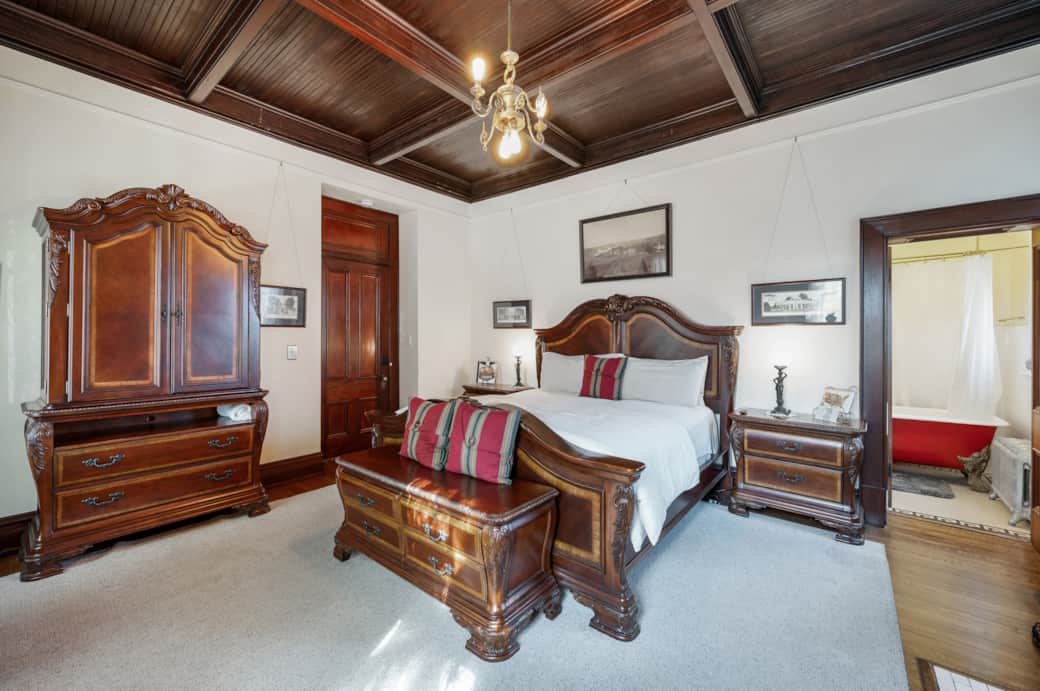 The bedroom is equipped with a king size bed,  coffee station, mini fridge, microwave, and armoire.