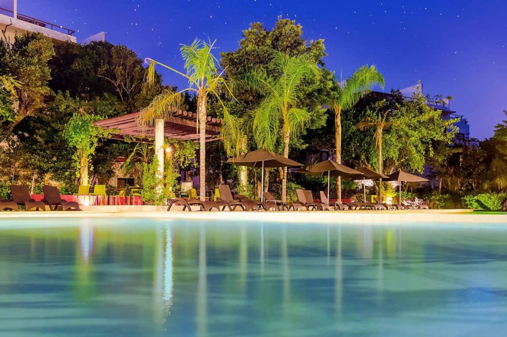 Enjoy the family infinity pool with a built-in kiddie pool, perfect for all ages. Relax on sun loungers under umbrellas, gather at the shaded pergola with outdoor furniture, use the BBQ grill, and rinse off in the outdoor showers during your stay.