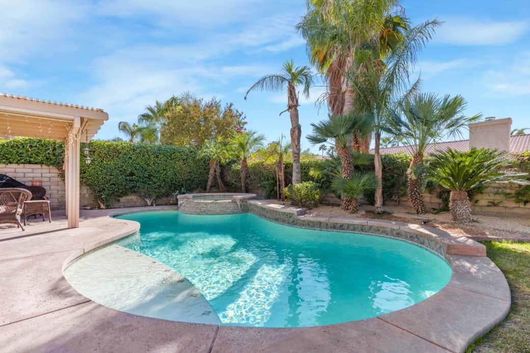 This stunning backyard oasis features a sparkling in-ground pool with a built-in spa, perfect for re This stunning backyard oasis features a sparkling in-ground pool with a built-in spa, perfect for re