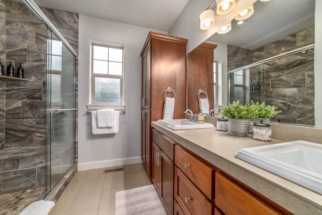 Primary bathroom with walk-in shower and dual sinks
