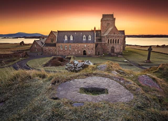 Iona Abbey overlooking the sea beneath a warm evening sky