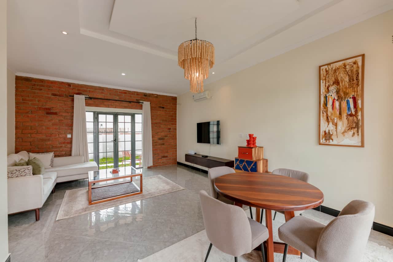 Bright living room with smart TV and dining area