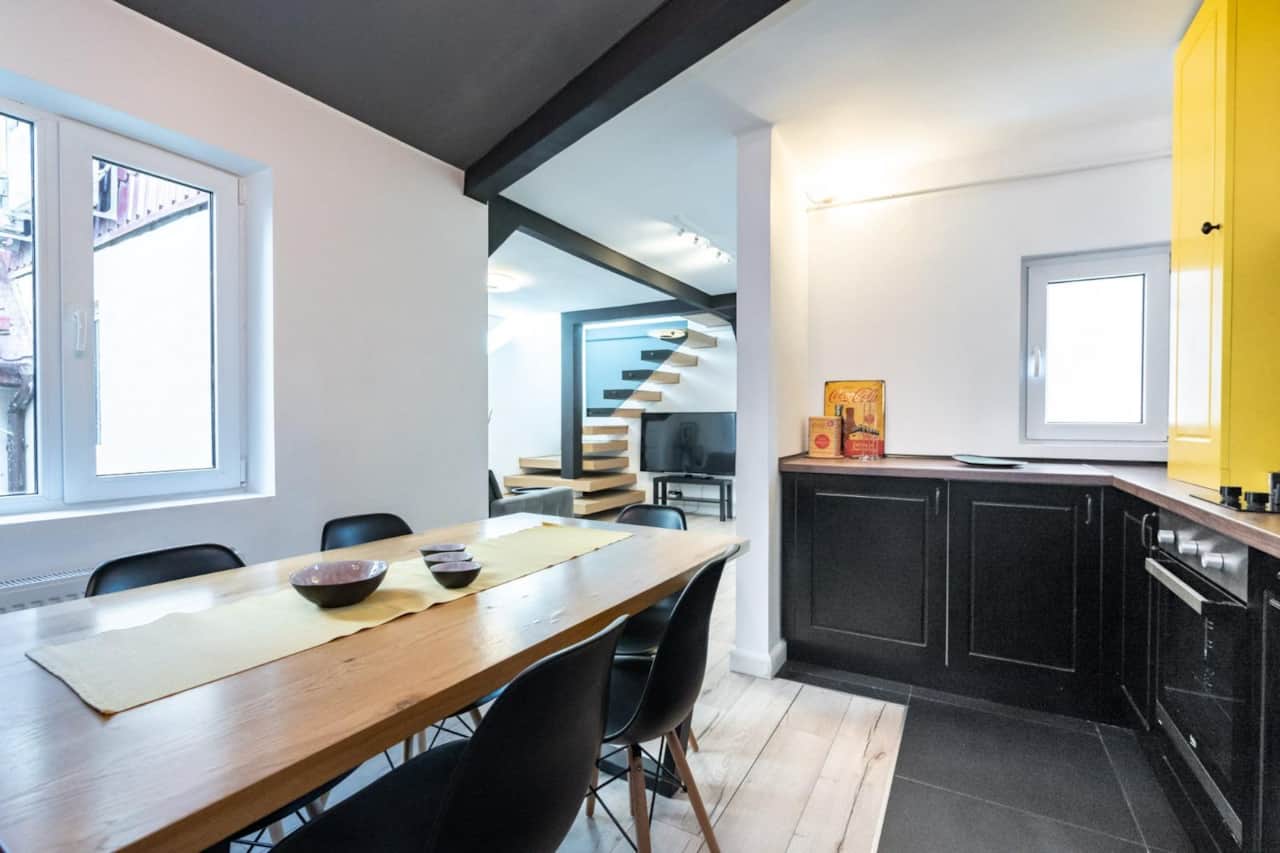 Open dining space connected to living room in 4-bedroom Bucharest duplex