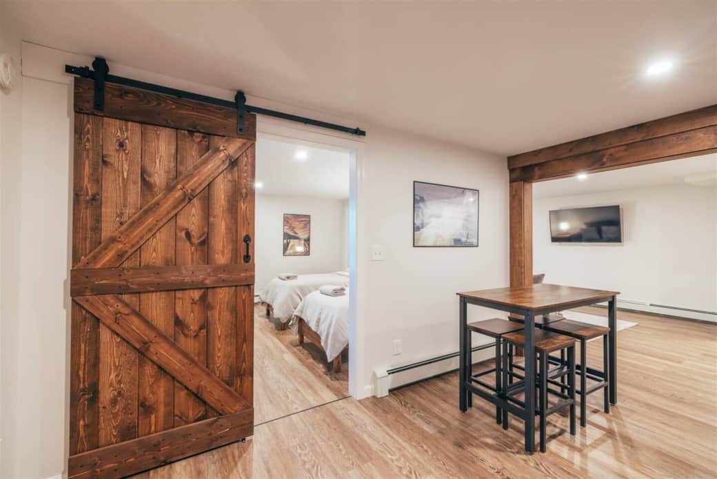 Spacious hallway with dining area and entrance into the two twin bedroom with TV