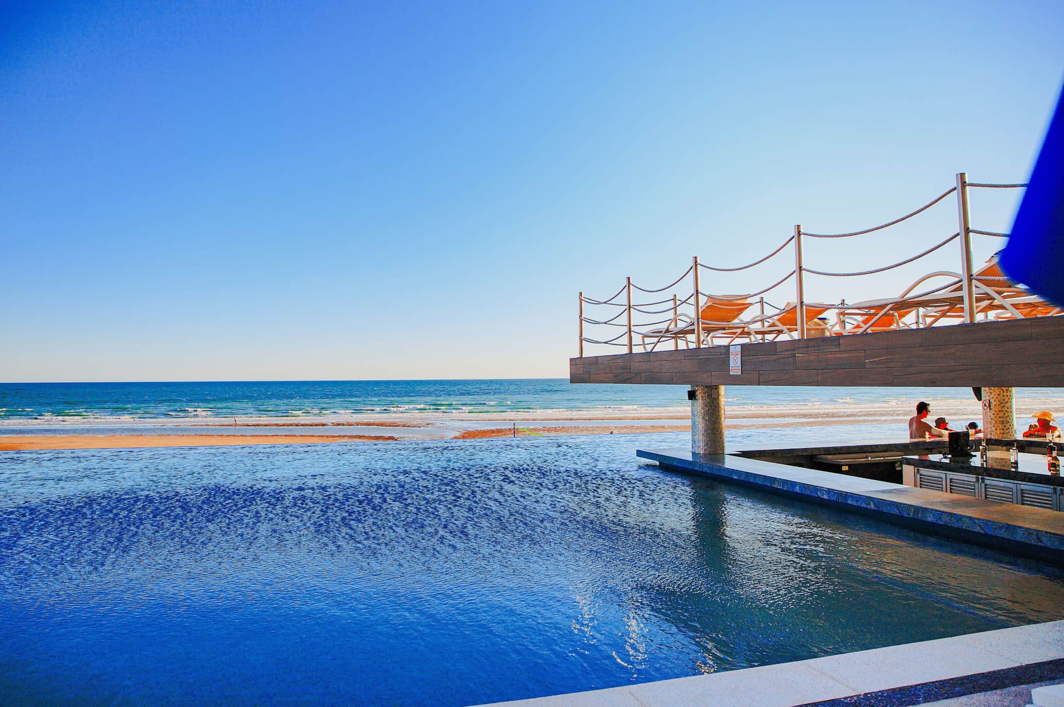Ground-level pool with a swim-up bar.