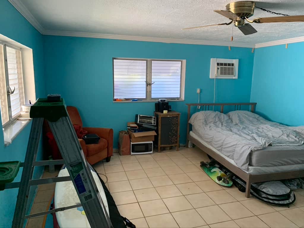 Before renovation Unit 1 at Casa Citron showing a dark interior with wall air conditioning