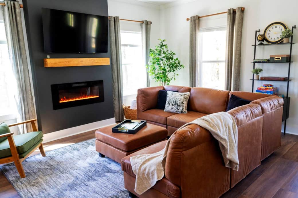Living room with plenty of seating, 55-inch Roku TV, and electric fireplace.