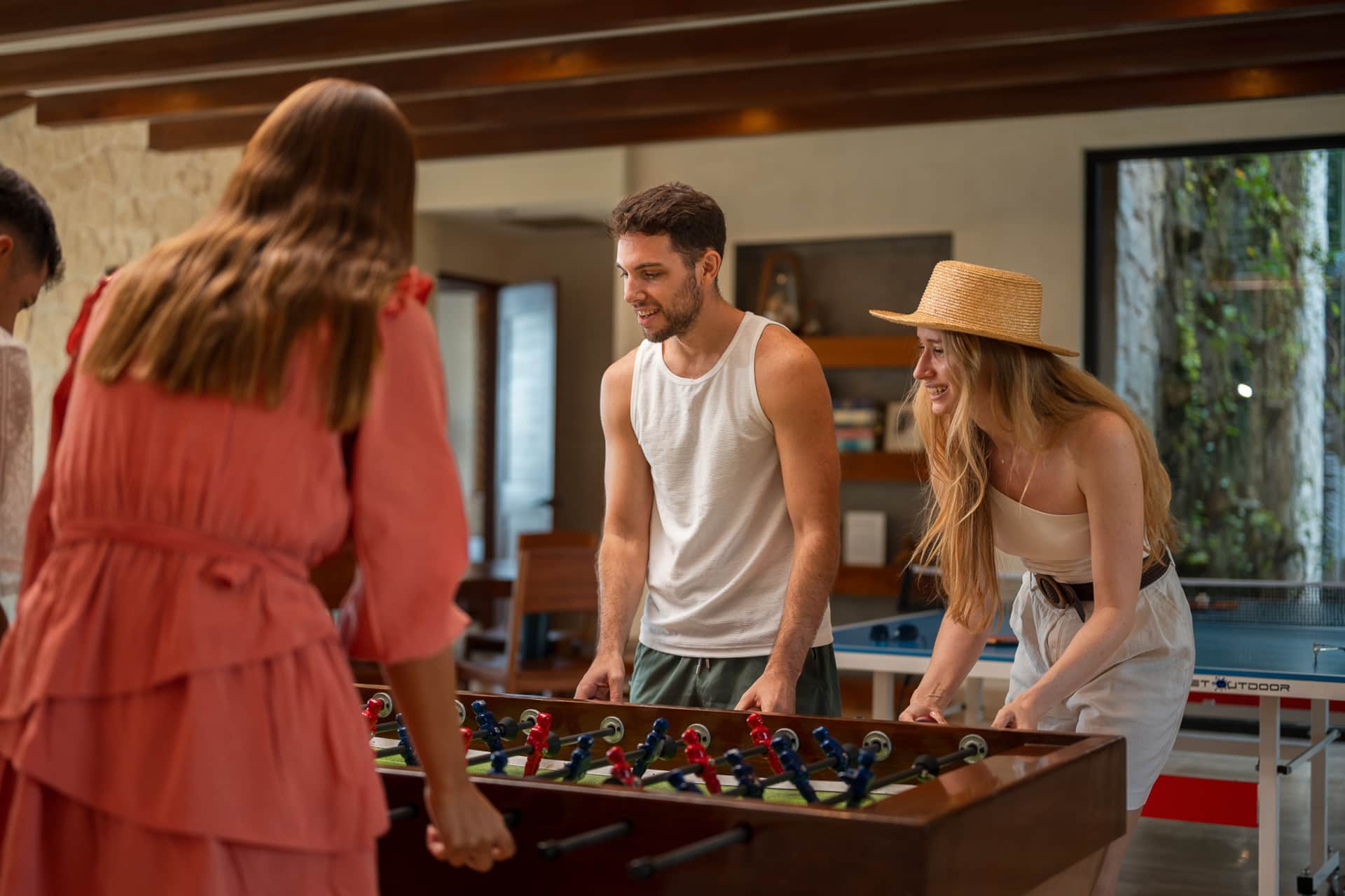 Guests playing foosball in Villa TuluMar game room