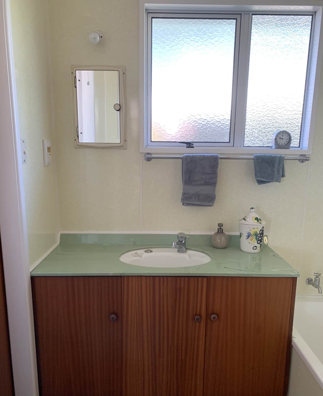 2nd bathroom: 1950's melamine walls and 1970s avocado sink! 1950s bathtub. Separate toilet.