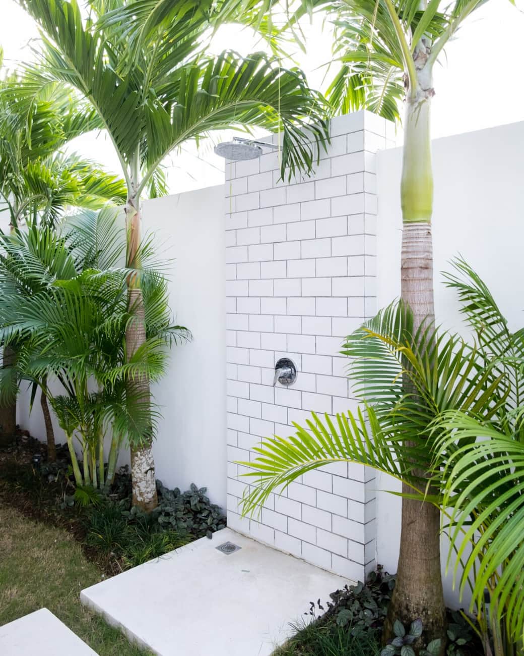 Refreshing outdoor shower surrounded by lush greenery. Ideal for cooling off after a swim or starting your day with nature.