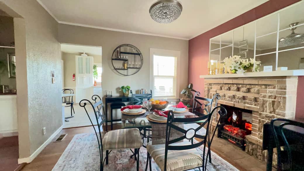 Dining room with electric fireplace and fan chandelier