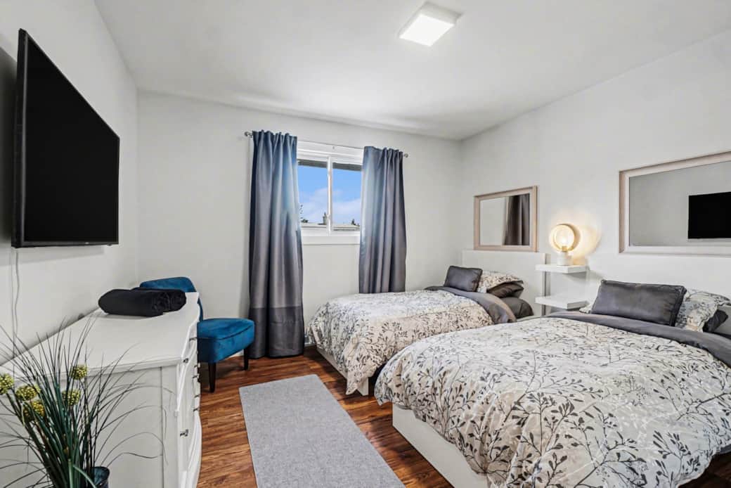 Two twin beds in bedroom #2. Soft linens and relaxing neutral tones for this Ottawa rental