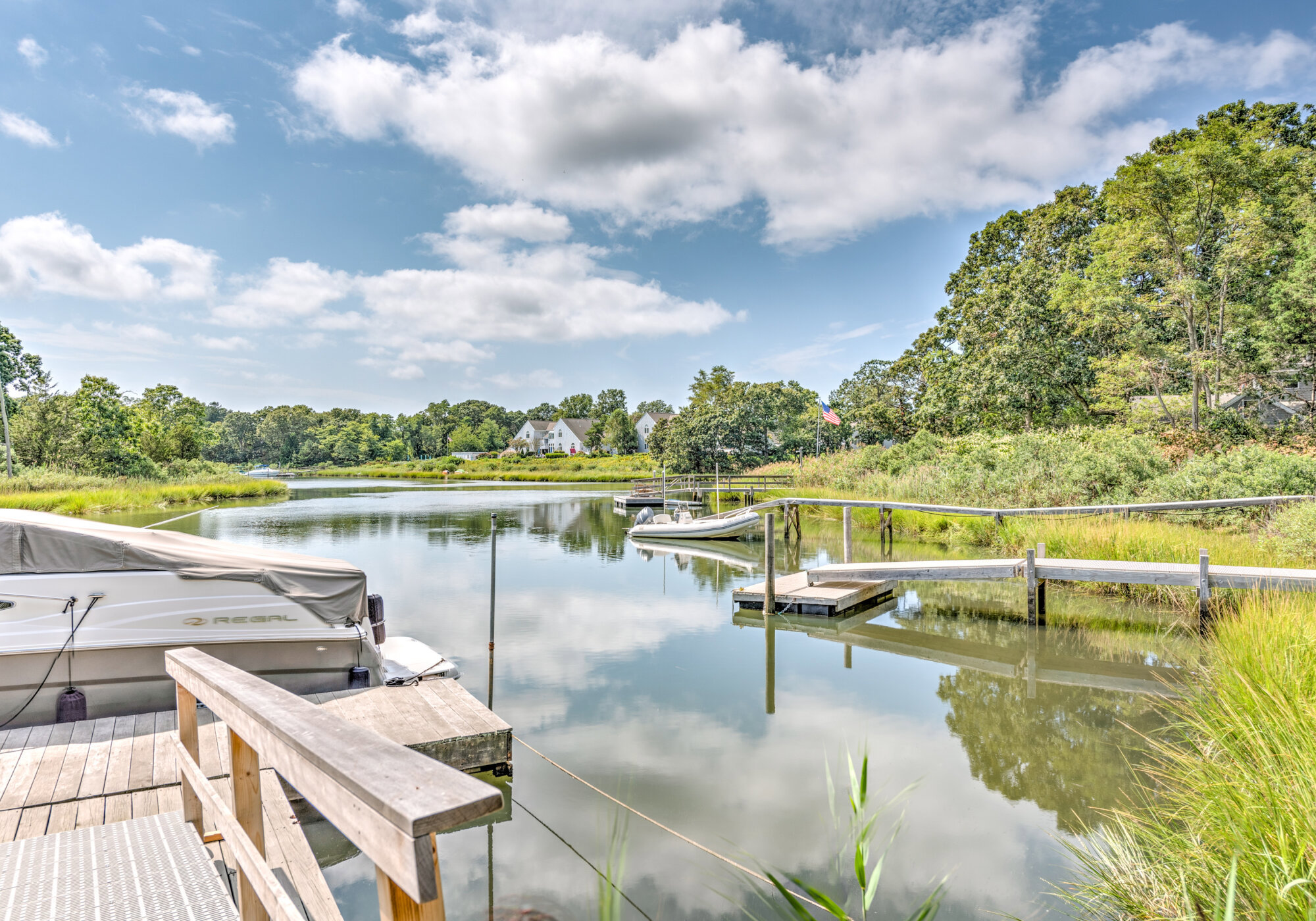 View from the private dock across Fish Cove, with a boat and the floating dock