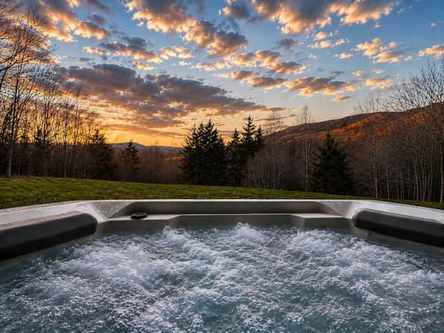 Unwind in the hot tub with breathtaking mountain views and unforgettable sunset skies.