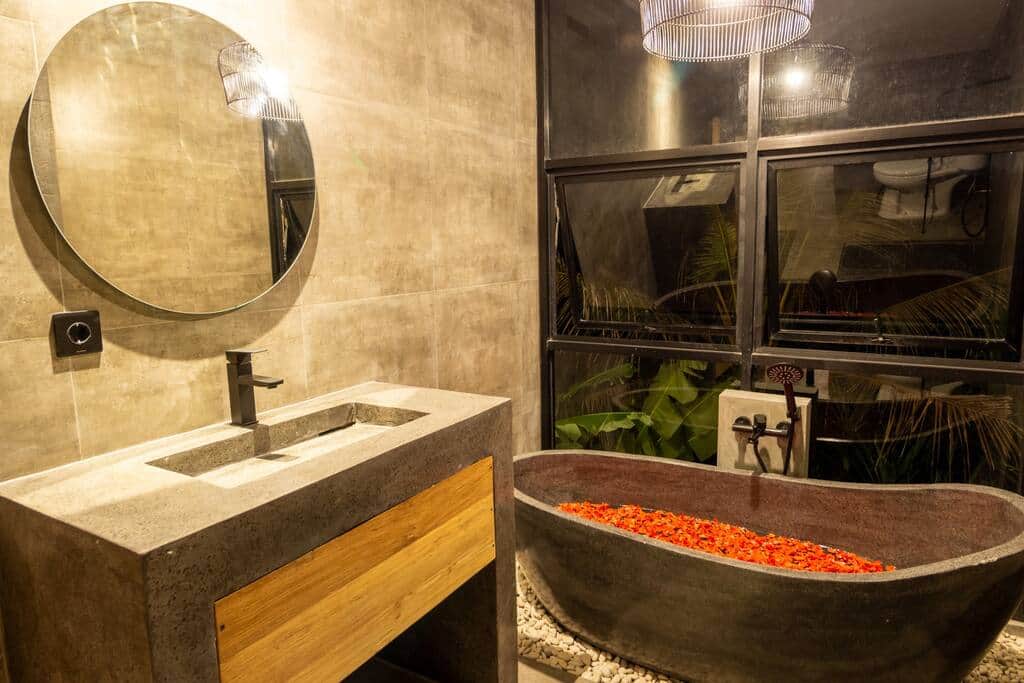 Chic en-suite bathroom with natural stone bathtub