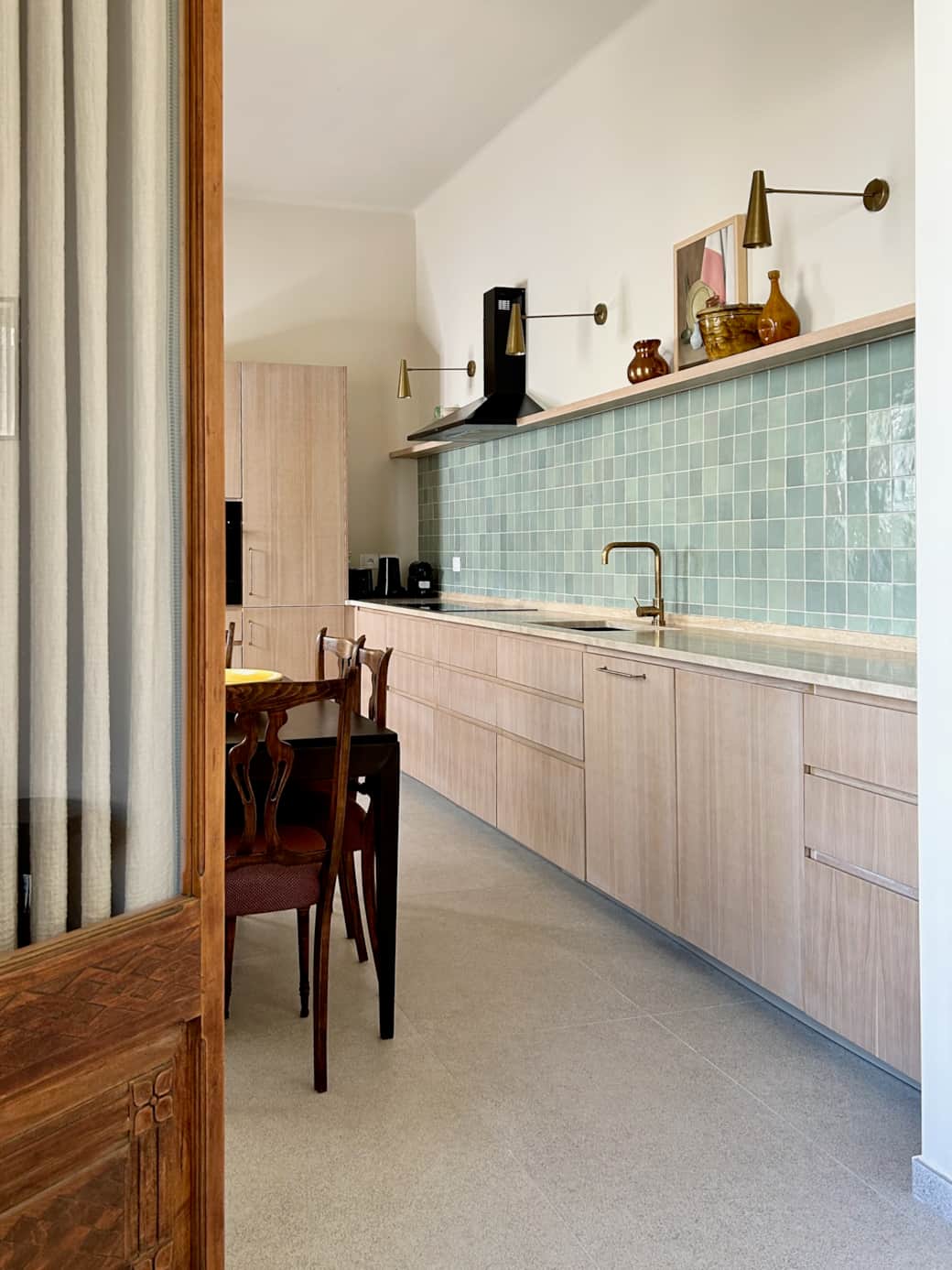 Luxe oak kitchen cabinets with accents of natural brass hand made tiles and marble countertops