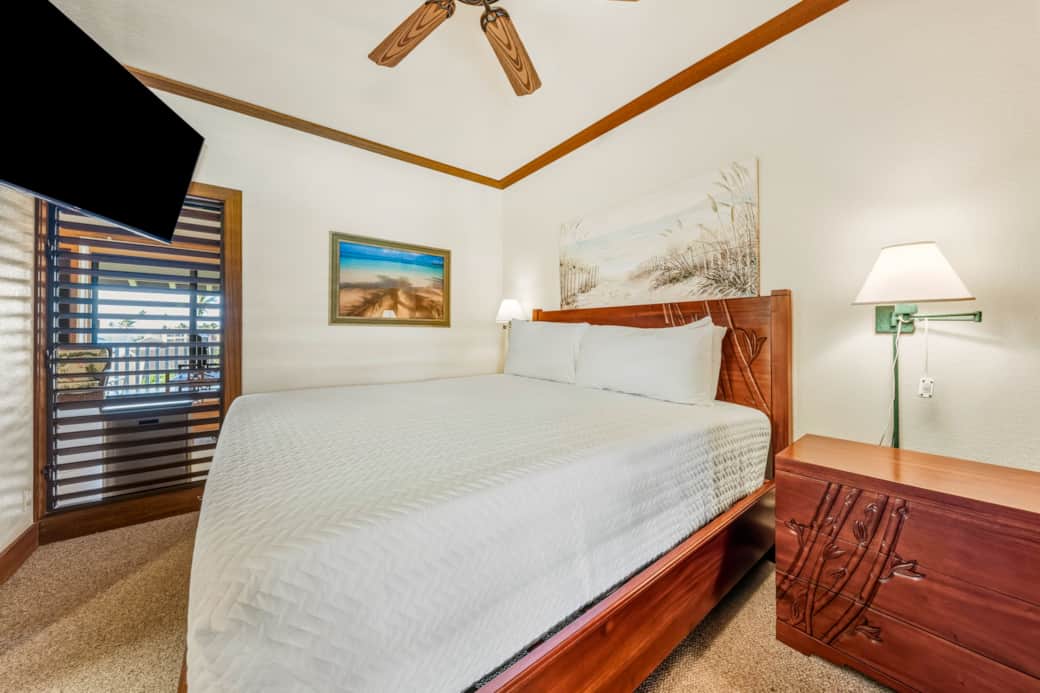Serene island bedroom with a plush bed, soft lighting, and tropical artwork.