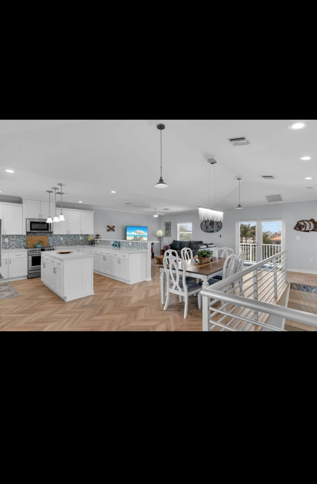 Kitchen, dining, and living area on top floor Kitchen, dining, and living area on top floor