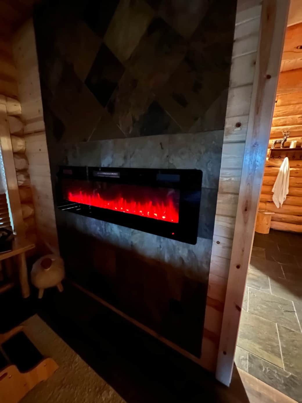 Electric fireplace by the bed in The Crescent Suite
