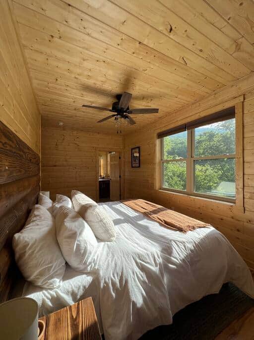 Luxurious king suite with comfy linens, ensuite bath, peaceful views, and plenty of natural light