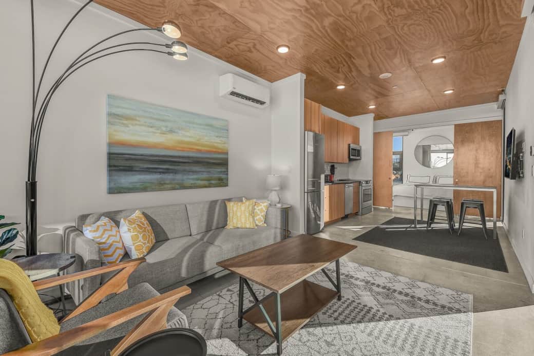 Living room, kitchen & dining area, tv, and bedroom is behind the sliding doors. The unit on the wall is the Heat & AC unit.