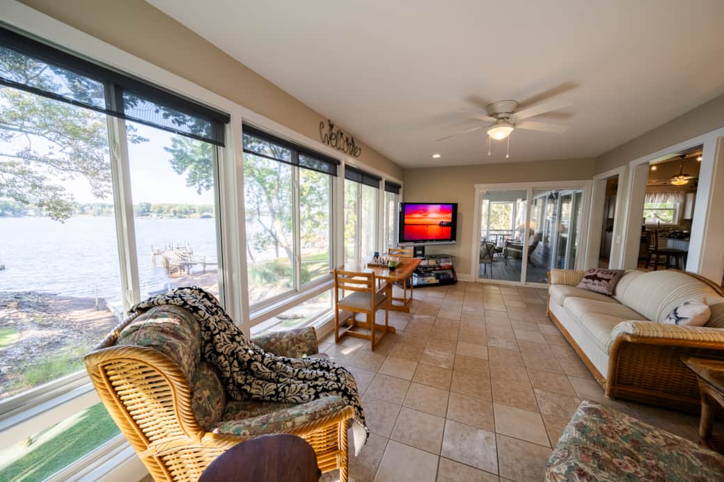 Sun room with access to living room, screen porch, and master balcony