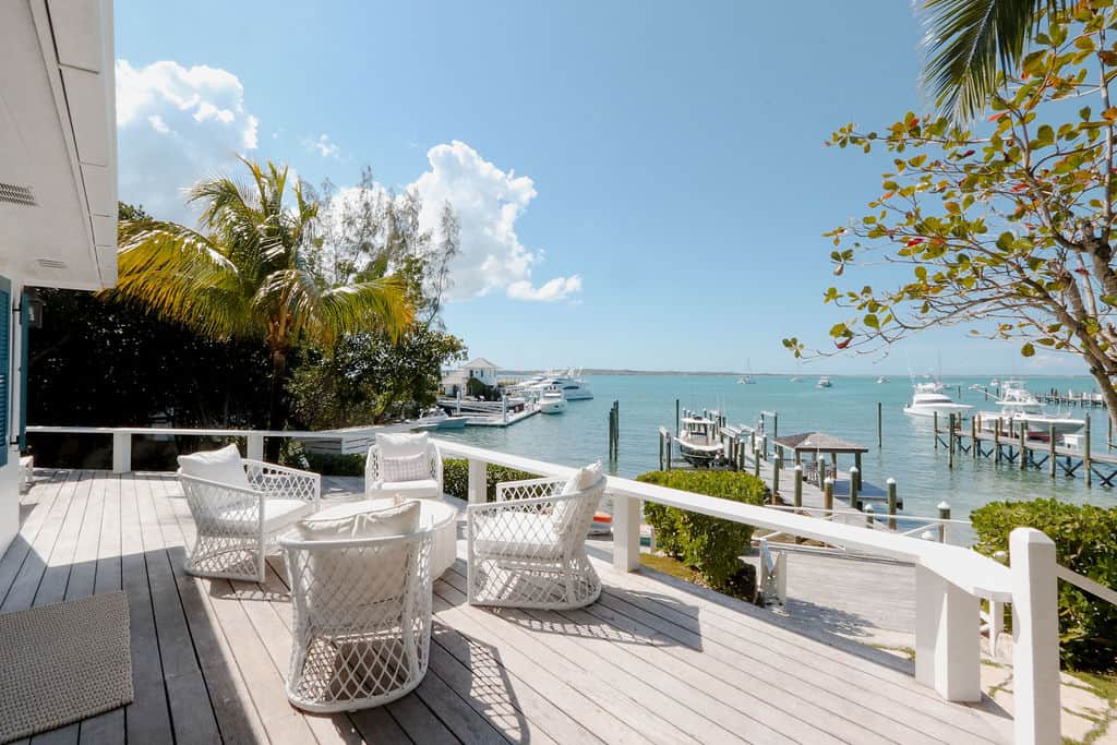 Outdoor lounge deck looking out at Low Tide's private dock on Harbour Island Bahamas.