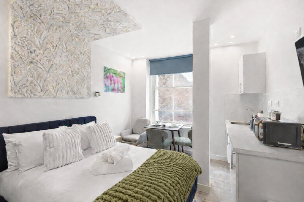 A bright, boutique-style bedroom with a luxurious double bed, stylish sofa and Smart TV with Netflix A bright, boutique-style bedroom with a luxurious double bed, stylish sofa and Smart TV with Netflix