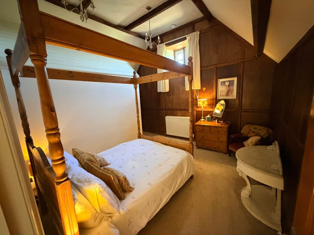 Bedroom 2 with wood panelling & chandeliers