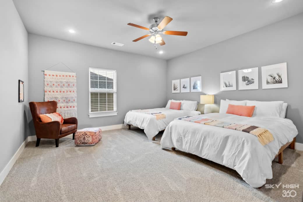 Two queen size beds in the upstairs guest bedroom