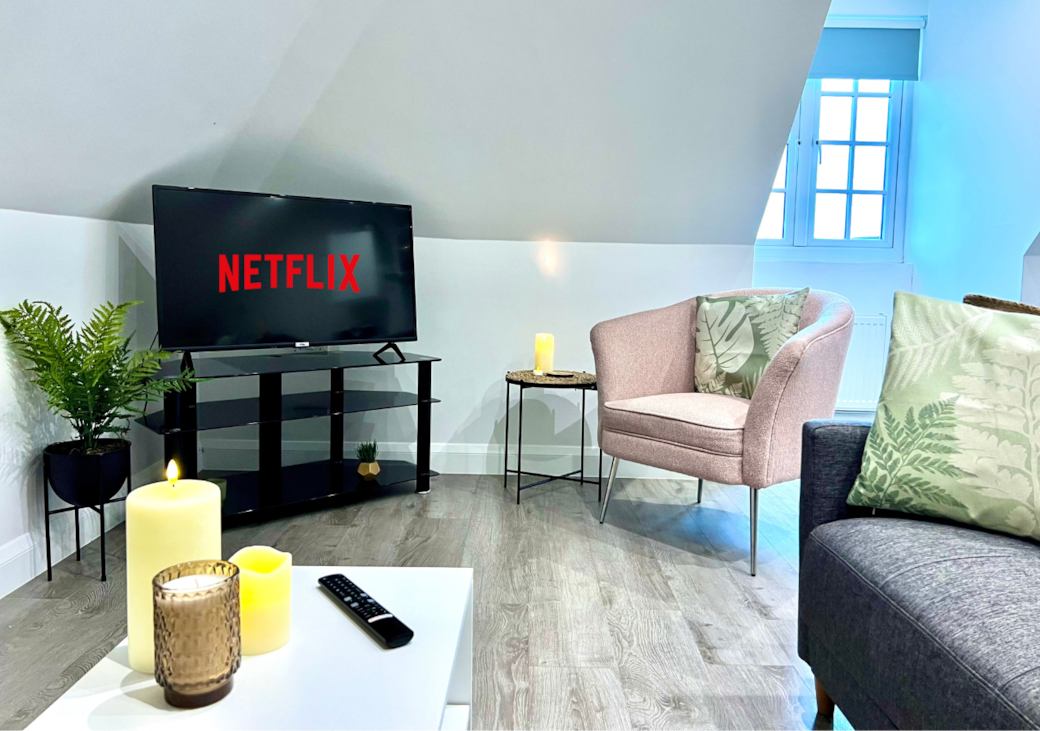 Living Area: Enjoy movie nights with Netflix and stylish seating in a bright, inviting space!