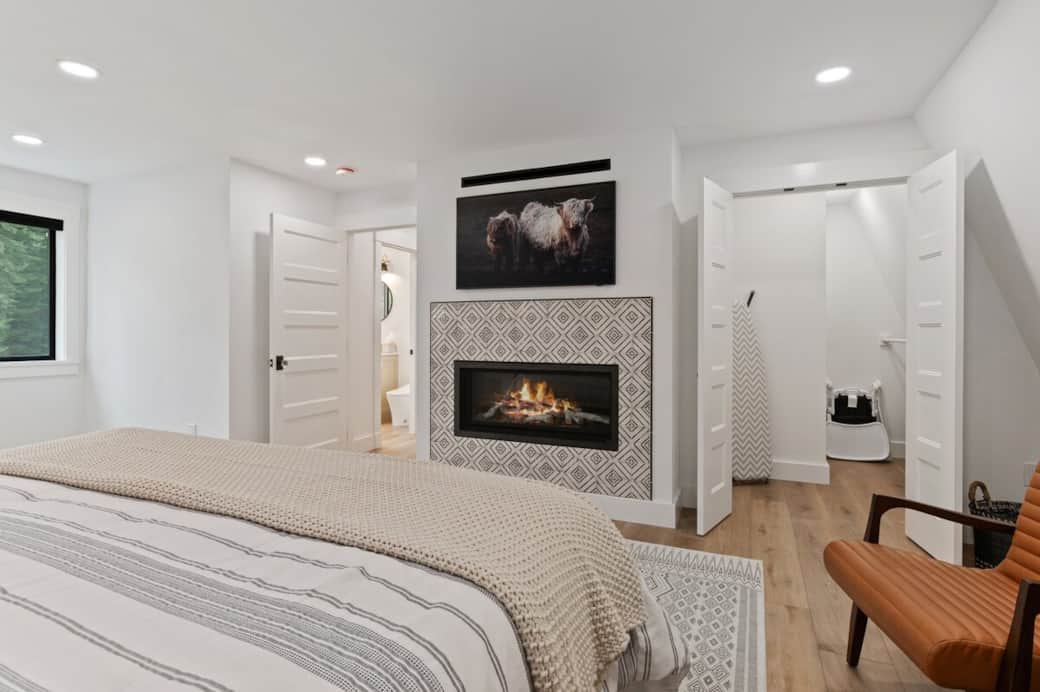 Hunter Douglas room-darkening shades allow you to watch your favorite Netflix movie or sleep in and rest your soul. A birch gas fireplace provides a cozy & warm retreat. The ironing board, porta-crib, & highchair are located in the closet. 