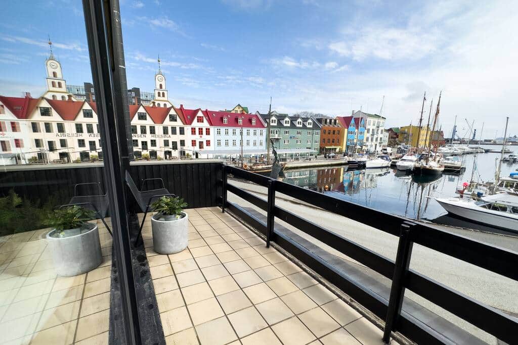 The balcony offers a unique view of the statue of local hero Nólsoyar Páll, right in front of you