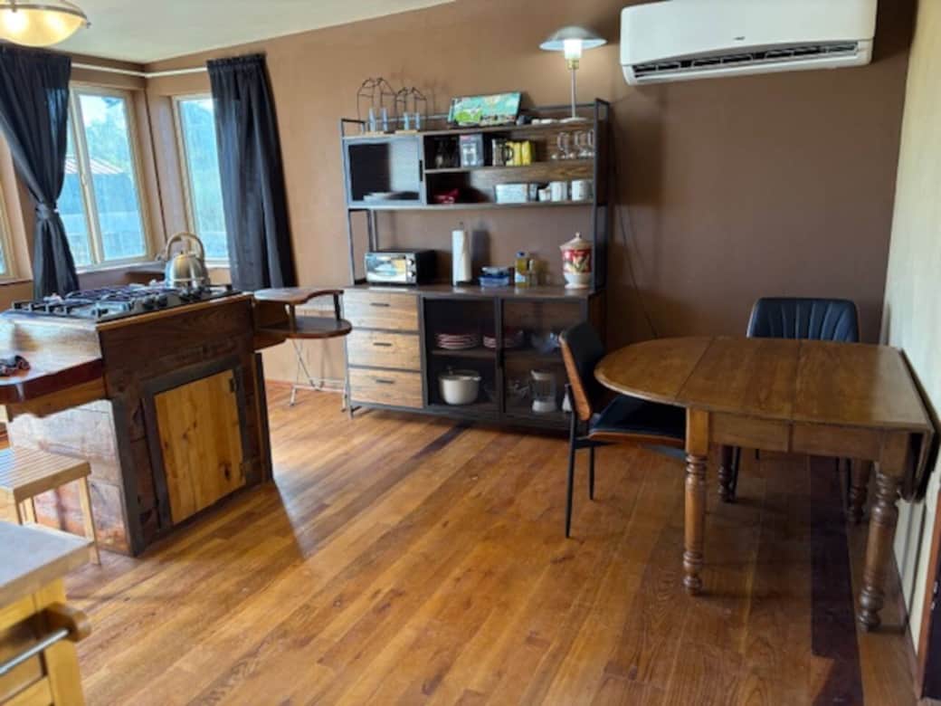 Kitchen features a handcrafted cabinet and counter around a propane stove.