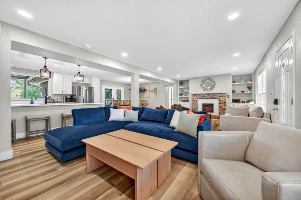 TV living room with plush seating and seamless flow into the kitchen and dining