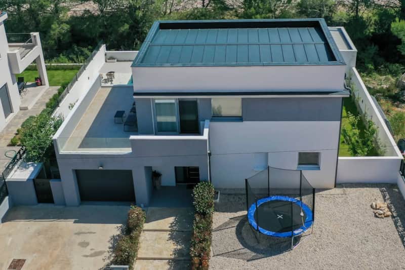 Aerial view of the villa with the trampoline in the garden