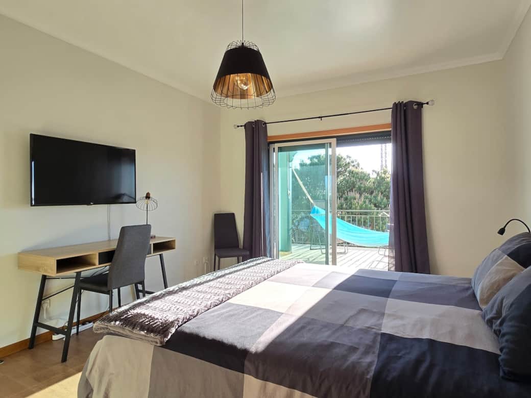 Bright and spacious bedroom with direct access to a private terrace, offering a peaceful and relaxing atmosphere. Each bedside table features a convenient charging cube with 220V outlets, plus USB and USB-C ports for easy device charging.