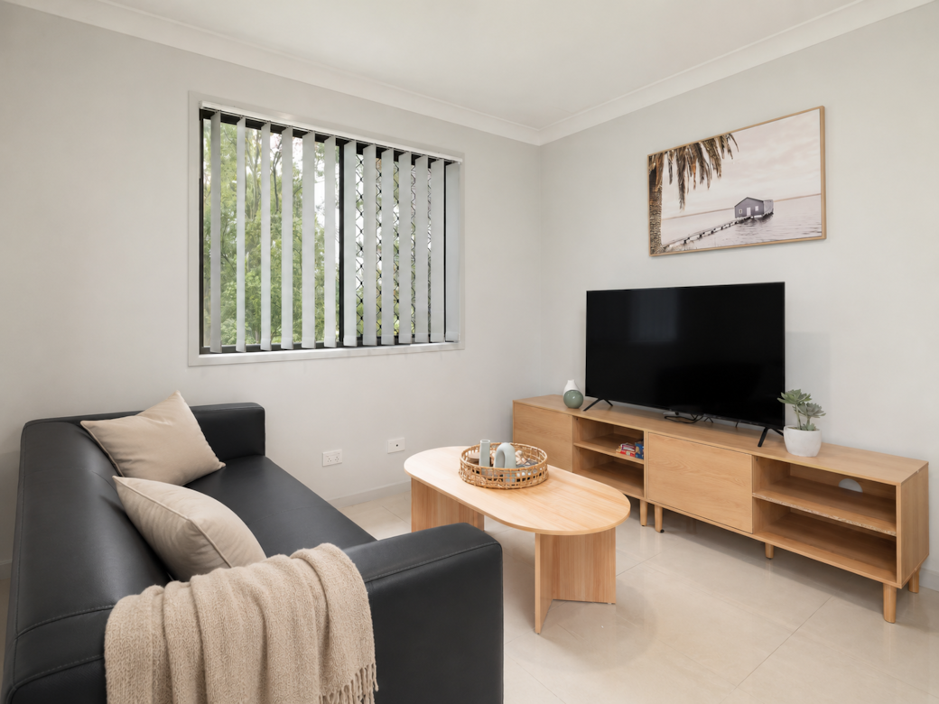 Living Area: Bright living space with comfortable seating and TV 