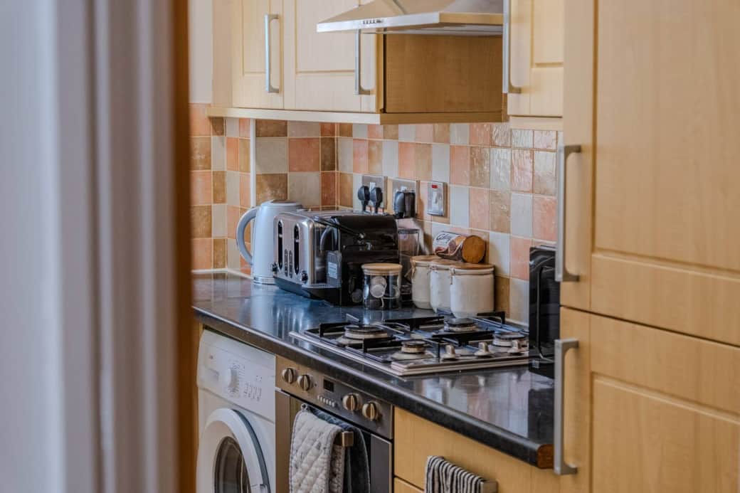 Kitchen with coffee machine, kettle, toaster, micorwave